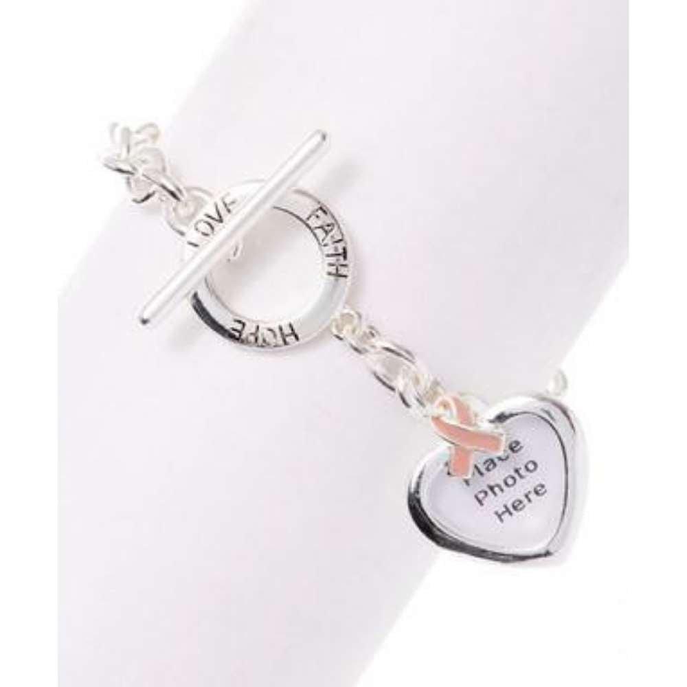 Silver charm bracelet with heart photo locket, cross, and circular charms