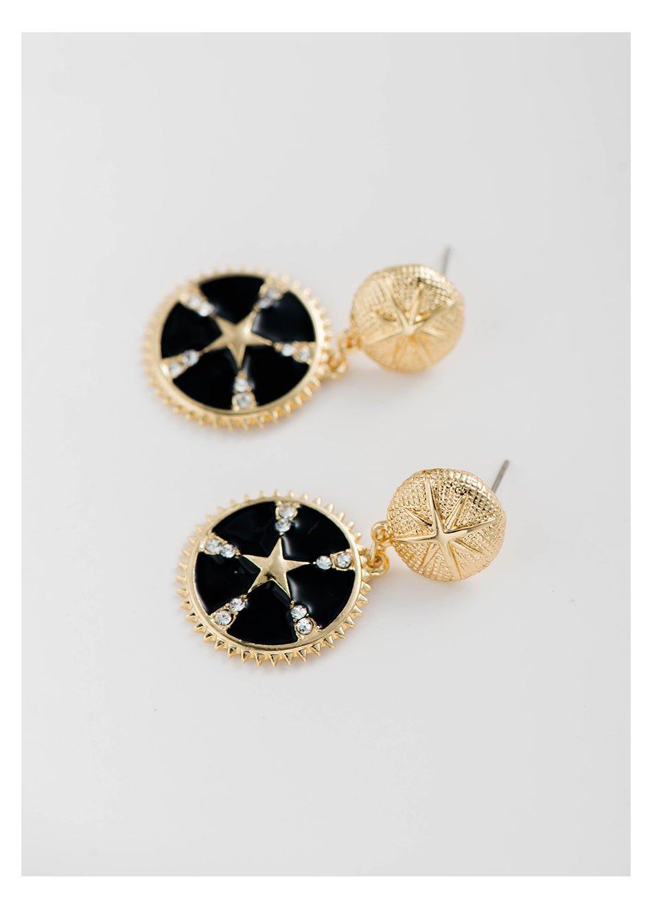 Gold-tone star dangle earrings with black enamel round drops, crystal accents, gold back