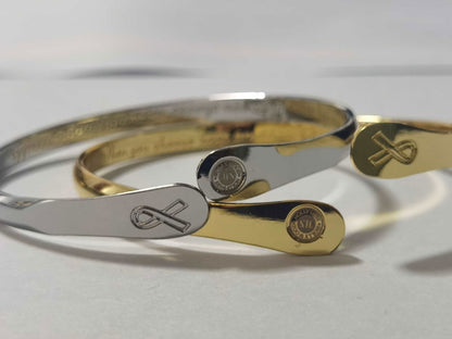 Pair of engraved bracelets, silver and gold cuffs with heart-and-arrow charm