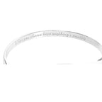 Silver engraved bracelet cuff showing inner message, ribbon emblem at center