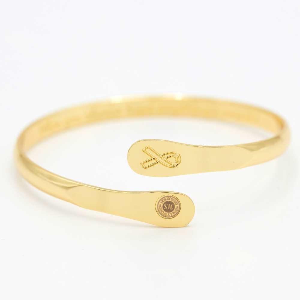 Gold awareness bracelet with ribbon charm and oval plaque medallion