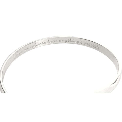 Silver engraved bracelet band with cursive message around the cuff