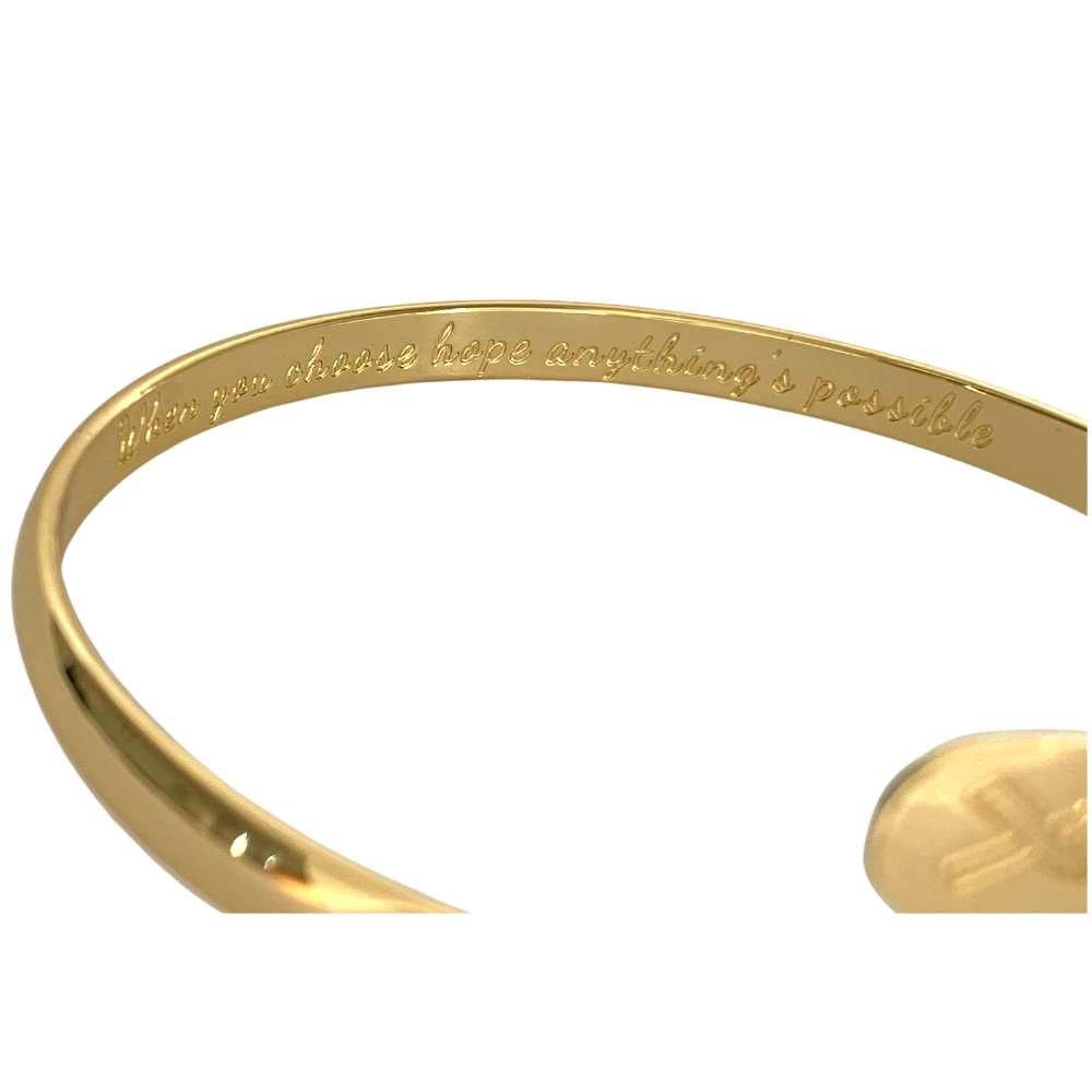Gold engraved metal bracelet with hope message along the cuff