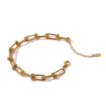 Gold chain link bracelet with oval charm and short extender chain