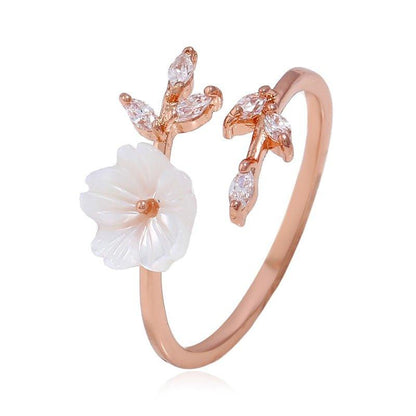 Adjustable floral ring with white flower design and rose-gold tone band