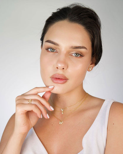 Adjustable floral ring with small white blossom on gold-tone band