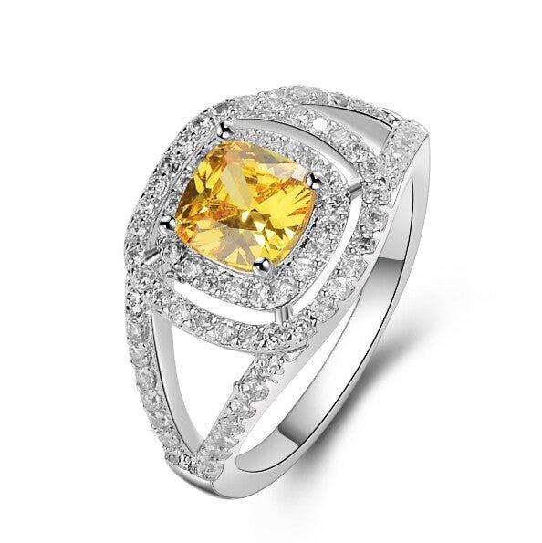 Silver-tone ring with yellow square-cut center crystal and sparkling halo accents