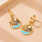 Gold-tone hoop drop earrings with turquoise enamel circle and pearl detail
