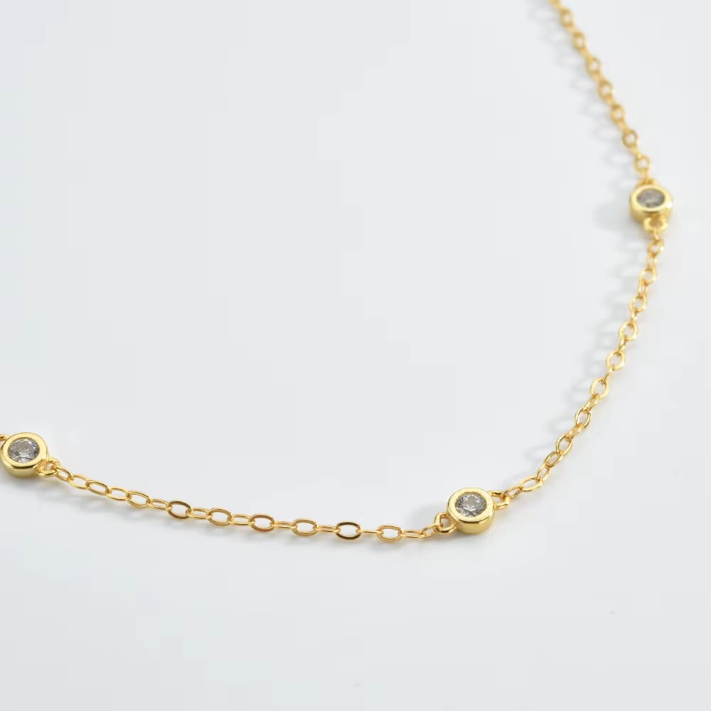 Close-up gold cubic zirconia bezel link bracelet with small round stones