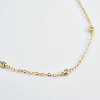 Close-up gold cubic zirconia bezel link bracelet with small round stones