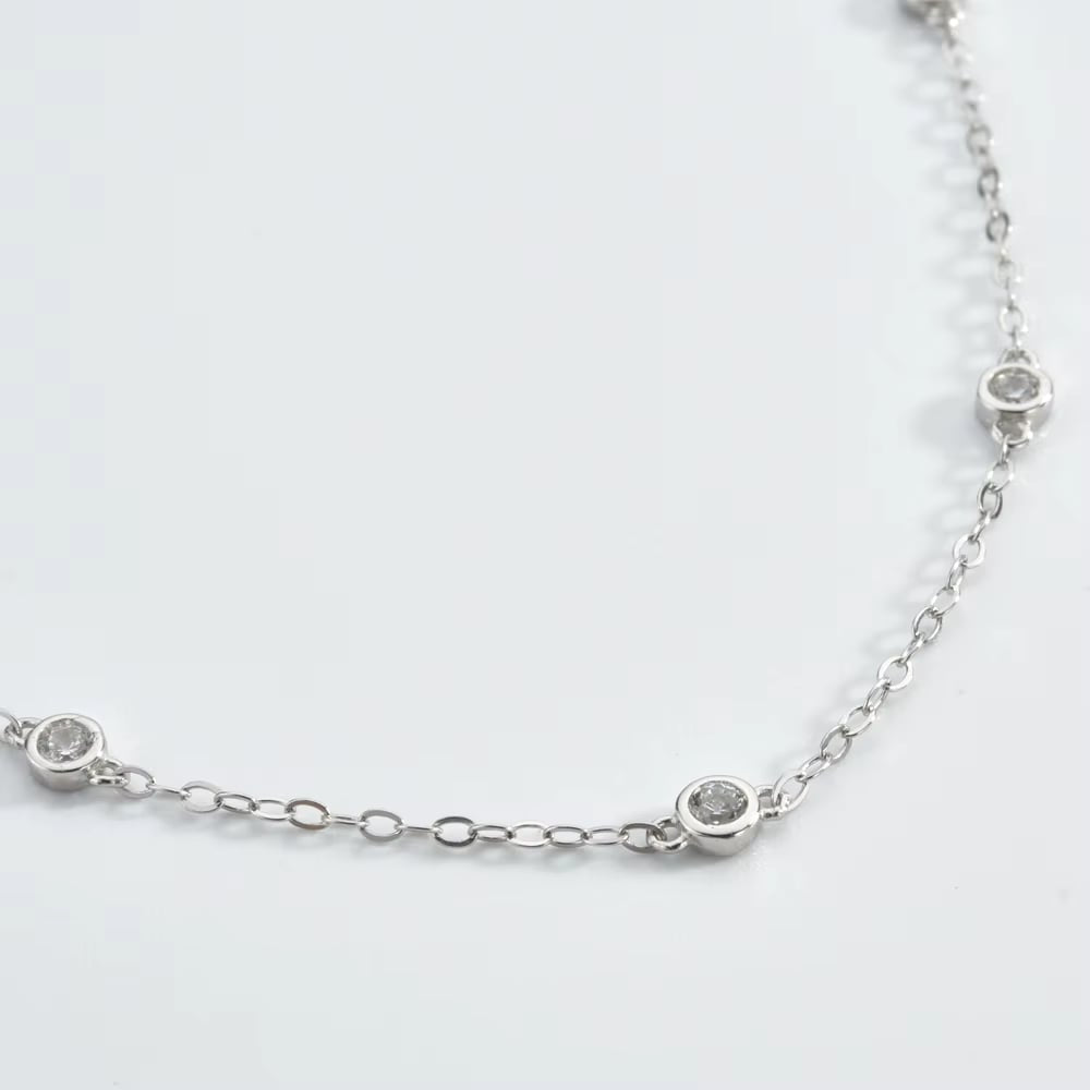 Close-up silver cubic zirconia bezel link bracelet with small round stones