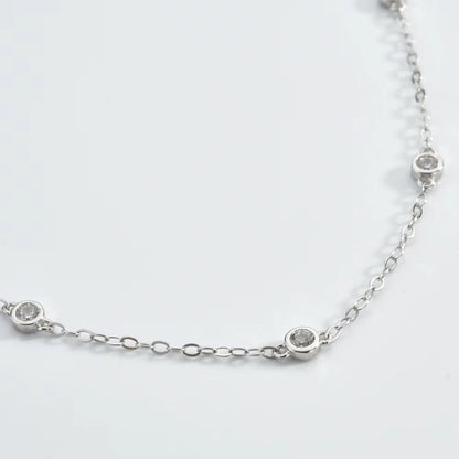 Close-up silver cubic zirconia bezel link bracelet with small round stones