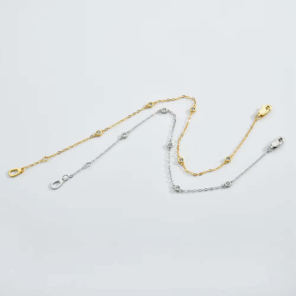 Gold and silver cubic zirconia bezel link bracelets with round stones and clasps