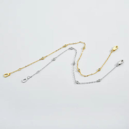 Gold and silver cubic zirconia bezel link bracelets with round stones and clasps