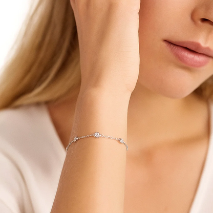 Silver-toned cubic zirconia halo bezel bracelet with small round center charm on chain
