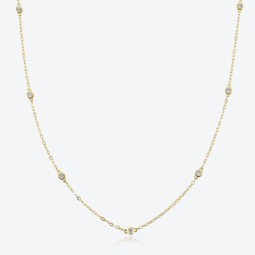 Gold-tone dainty necklace with round cubic zirconia halo bezel accents along chain