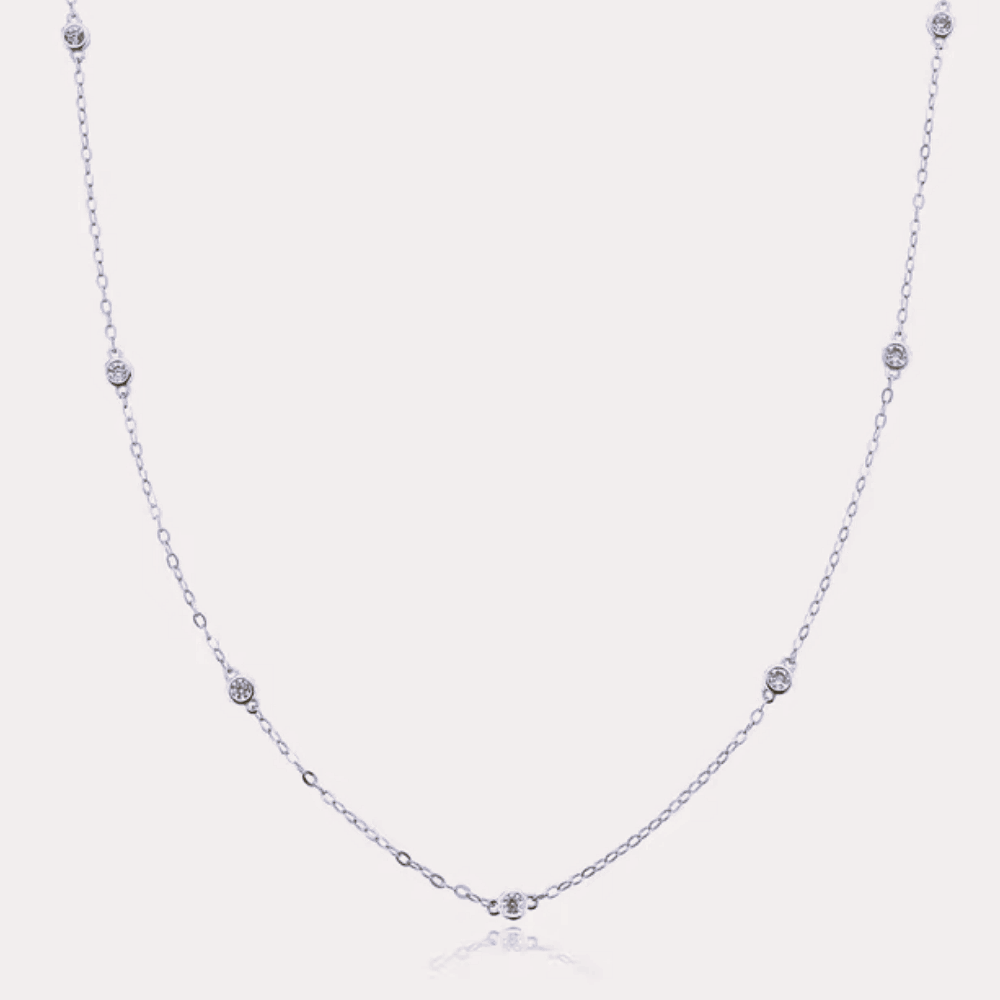 Silver-tone dainty necklace with round cubic zirconia halo bezel accents along chain