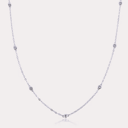 Silver-tone dainty necklace with round cubic zirconia halo bezel accents along chain