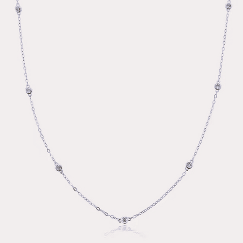 Silver-tone dainty necklace with round cubic zirconia halo bezel accents along chain