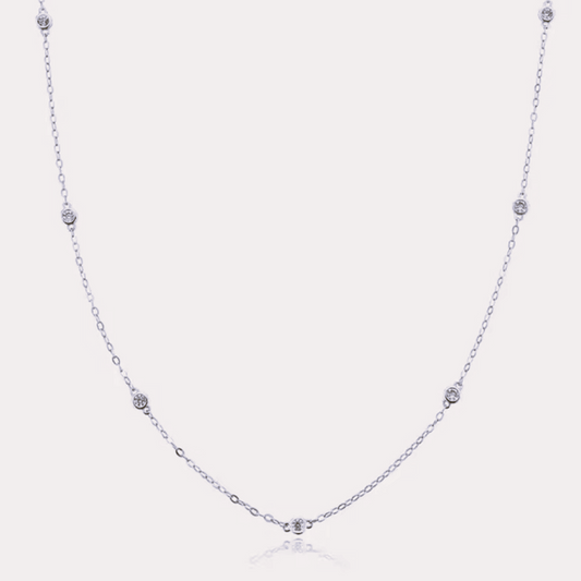 Silver-tone dainty necklace with round cubic zirconia halo bezel accents along chain