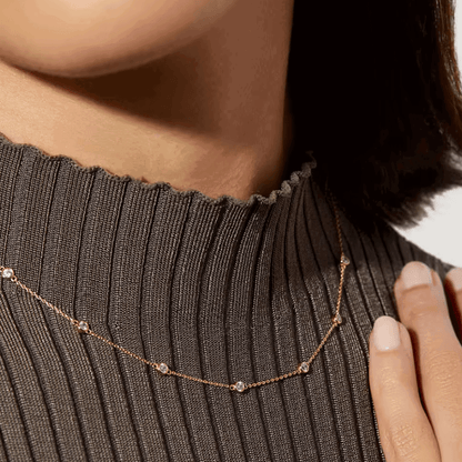 Gold-tone necklace with small round cubic zirconia bezel stones on thin chain