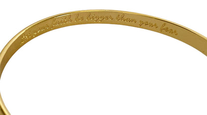 Gold bracelet band close-up showing engraved faith text along the outer edge