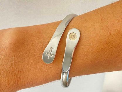 Silver bracelet with cross charm detail and oval engraved tag