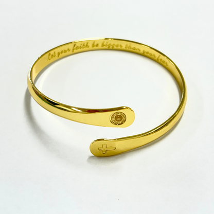 Gold cross cuff bracelet with engraved faith quote, round medallion center, open end