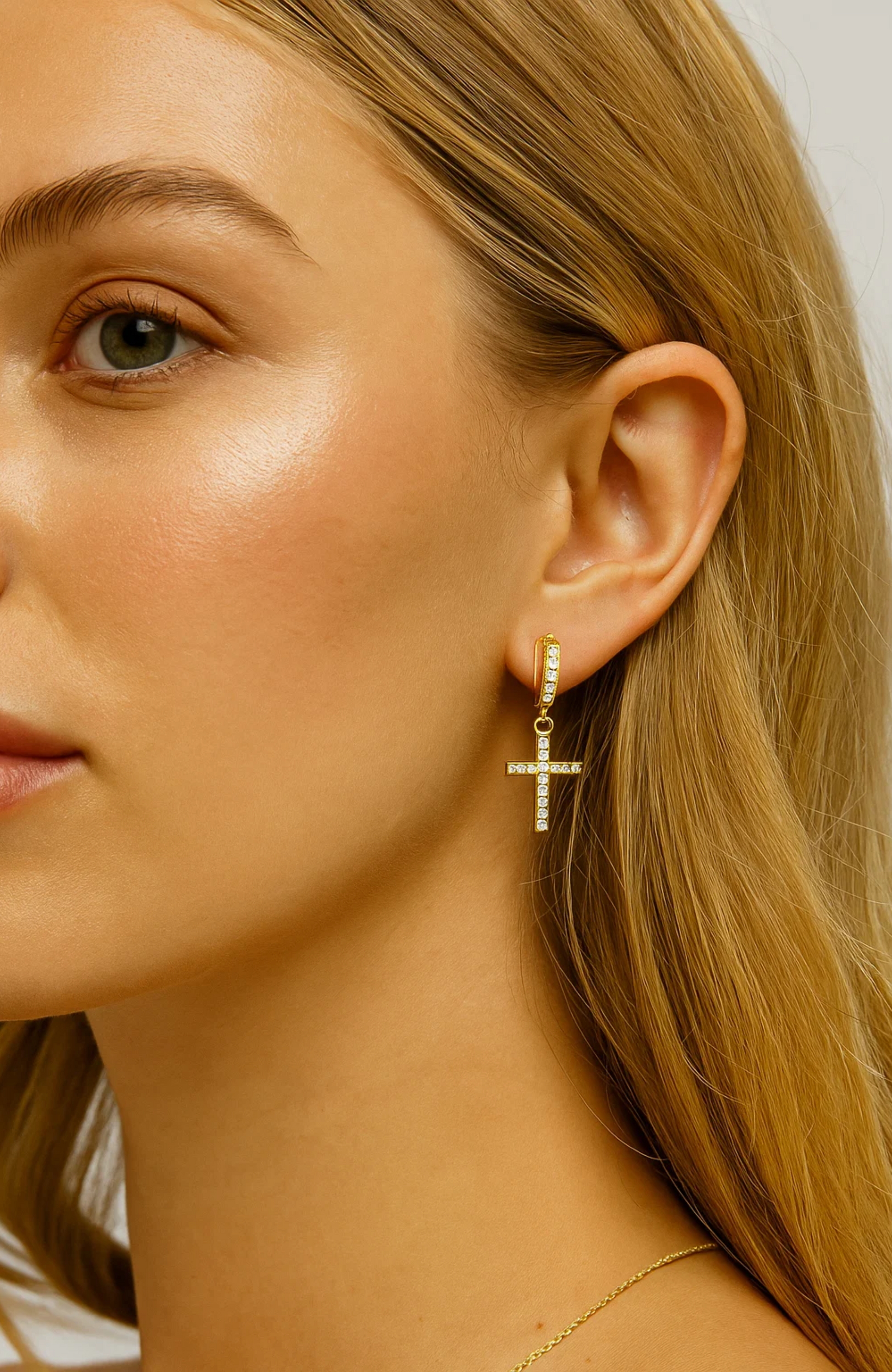 Gold hoop cross dangle cubic zirconia earrings worn, side profile view