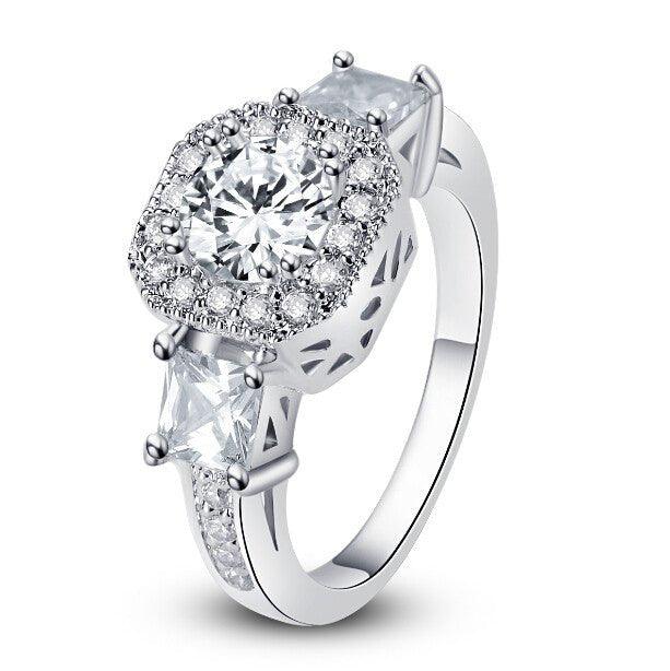 Cubic zirconia halo engagement ring with raised round center stone, openwork sides