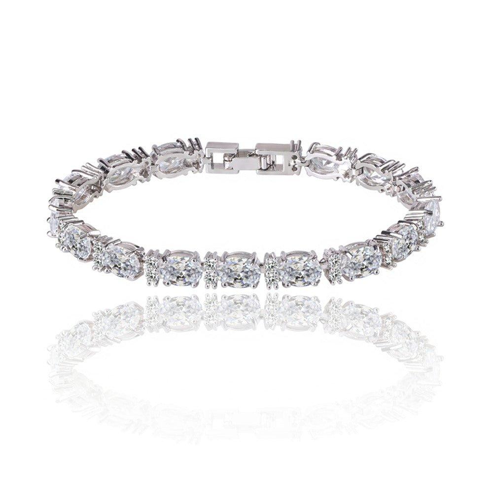 Silver-tone tennis bracelet with oval and round cubic zirconia stones, clasp detail