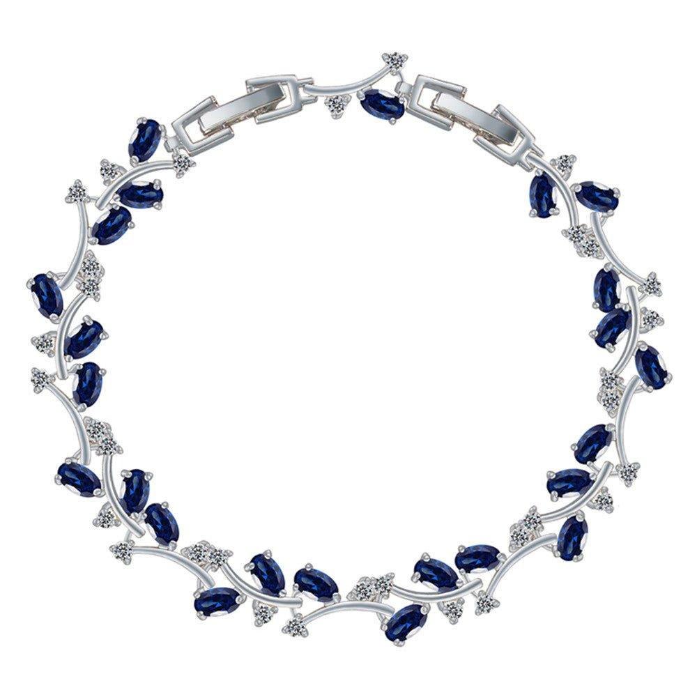 Sapphire blue tennis bracelet with oval CZ stones and silver-tone link frame