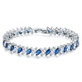 Marquise-cut blue and clear tennis bracelet with silver-toned links and hinged clasp