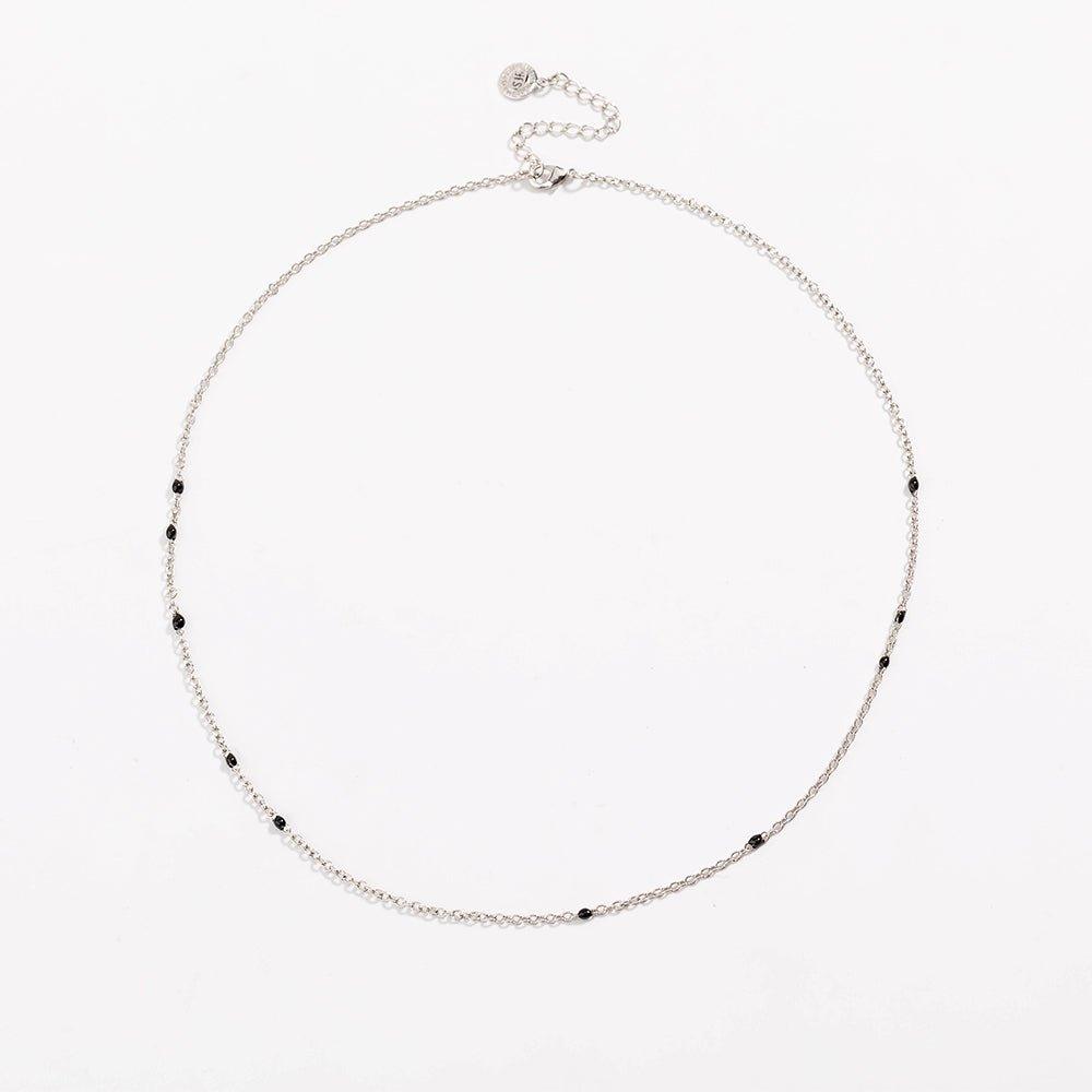 Silver link necklace with small black bead stones along the chain