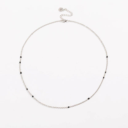 Silver link necklace with small black bead stones along the chain