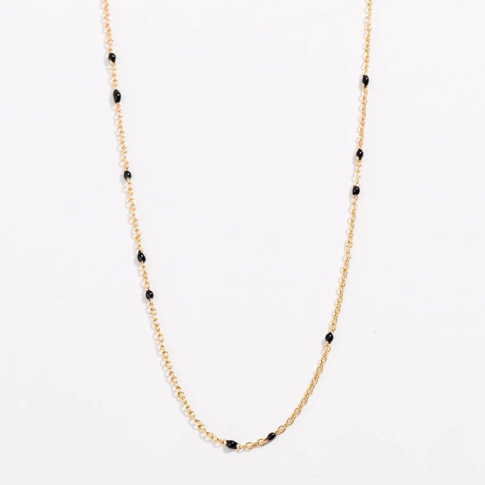 Gold link necklace with black bead stations along the chain