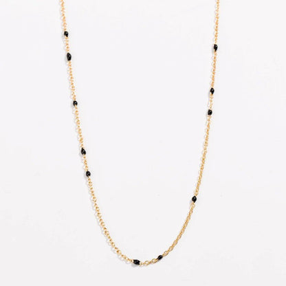 Gold link necklace with black bead stations along the chain