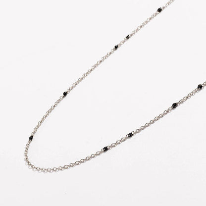 Gold-tone beaded link necklace with small black onyx-style beads, U-shape.