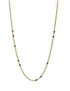 Gold-tone beaded link necklace with black onyx-style beads, full front view.