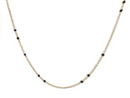 Gold-tone beaded link necklace with black onyx-style beads, close V-shape.