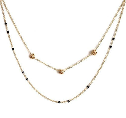 Gold-tone beaded link necklace with black beads and small heart charm.
