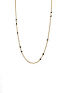 Gold-tone beaded link necklace with black onyx-style beads, minimal close V.