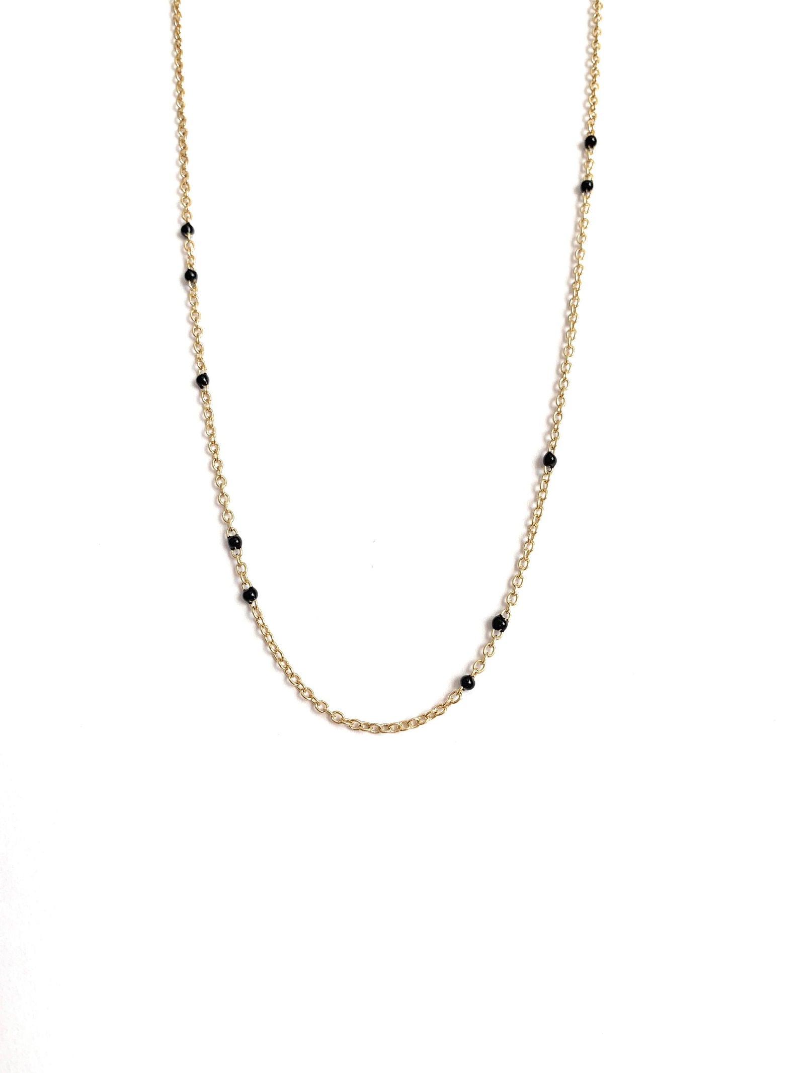 Gold-tone beaded link necklace with black onyx-style beads, minimal close V.
