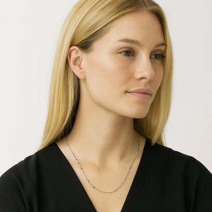Silver beaded link necklace with dark onyx stones, slim chain with evenly spaced beads.