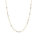 Gold link necklace with small black bead accents along the chain