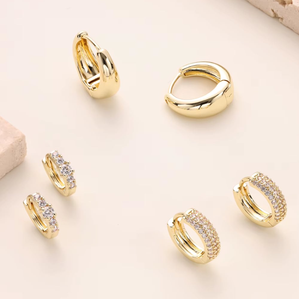 Gold huggie hoop earrings set with smooth and stone-detailed hoops