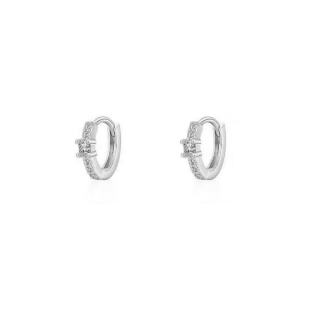 Silver huggie hoop earrings with clear stones on the front, shown as a pair