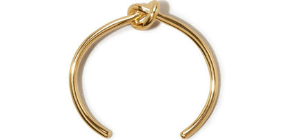 Gold love-knot bangle bracelet with a twisted knot centerpiece