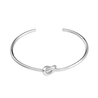 Silver love-knot bracelet with a twisted knot clasp at the center
