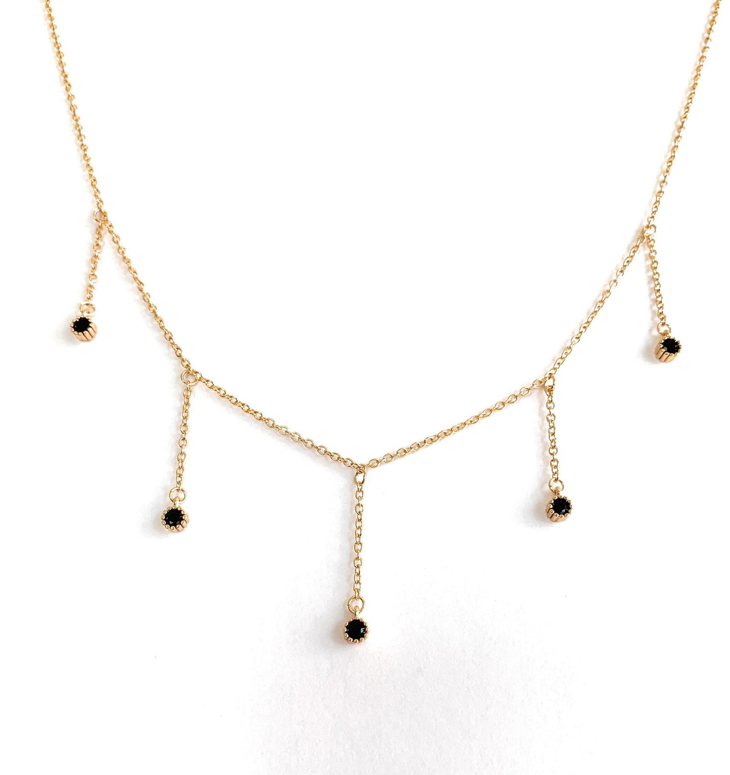 Gold drop necklace with five black cubic zirconia dangle stones